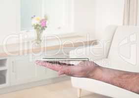 Hand holding phone with sitting room