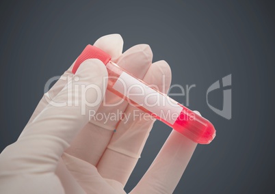 Gloved hand with red container against grey background