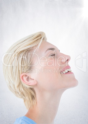 Close up of business woman eyes closed with flare against white wall