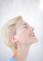Close up of business woman eyes closed with flare against white wall
