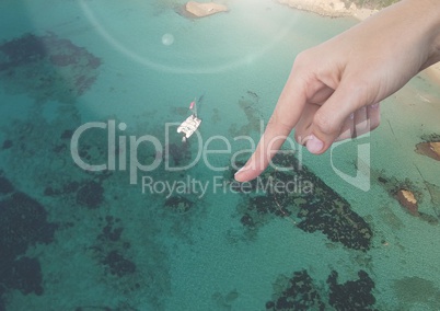 Hand pointing in air over sunny seaside resort