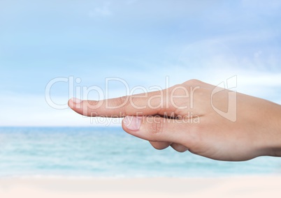 Hand touching  air with sea horizon