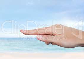Hand touching  air with sea horizon