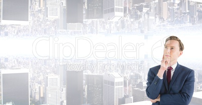 Thoughtful businessman with upside down city in background