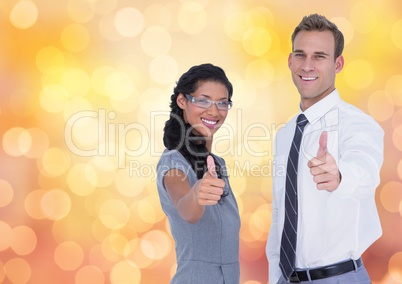 Portrait of confident business people showing thumbs up over bokeh