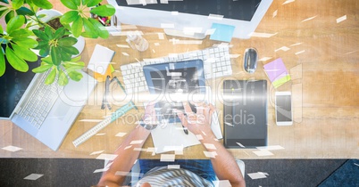 Business person using digital tablet at desk with overlay