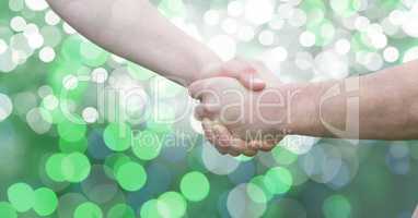 Couple holding hand over bokeh