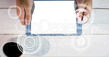 Digital composite image of hands holding tablet PC with blank screen