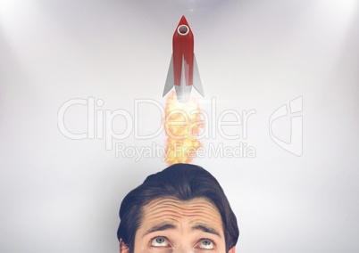 Businessman looking at rocket over head