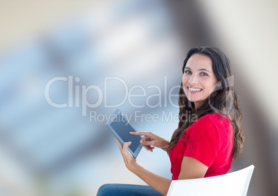 Portrait of smiling woman using digital tablet against blurred background