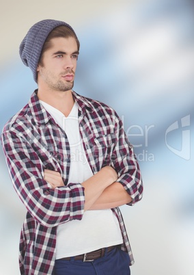 Thoughtful male hipster standing arms crossed