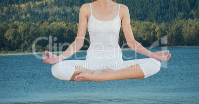 Double exposure of woman meditating over lake