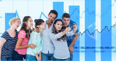 Casual business people taking selfie on smart phone against graphs