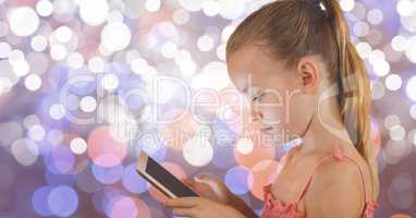 Girl using digital tablet over bokeh