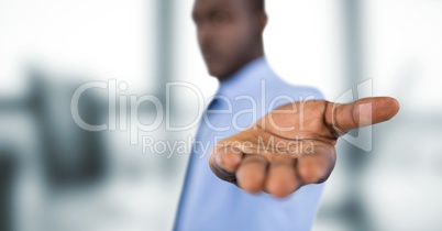 Businessman offering hand over blurred background