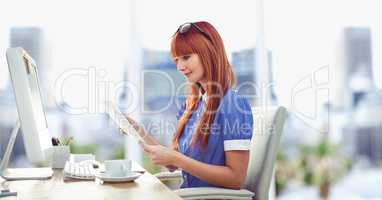 Businesswoman reading document at desk in office