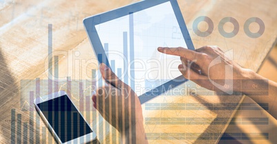 Close-up of hand touching digital tablet's screen with overlay