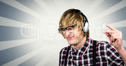 Male hipster using headphones over abstract background