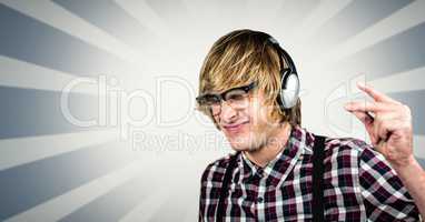 Male hipster using headphones over abstract background