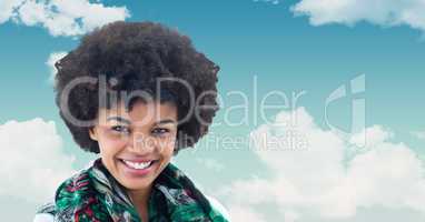 Smiling woman with curly hair against sky