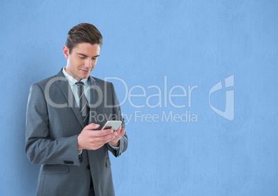 Businessman holding smart phone over blue background