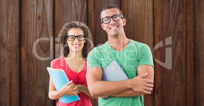 Portrait of happy business colleagues standing against wooden wall