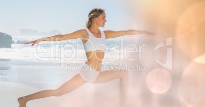 Fit young woman practicing yoga at beach