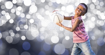 Happy kid playing with ball over bokeh