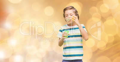 Little boy playing with soap bubbles