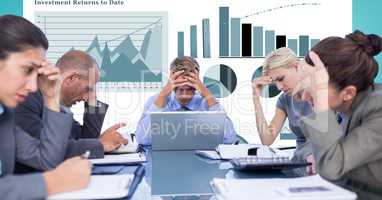 Tensed business people with head in hands against graphs