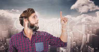 Hipster pointing upwards against city