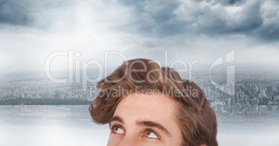 Young man with brown hair against city