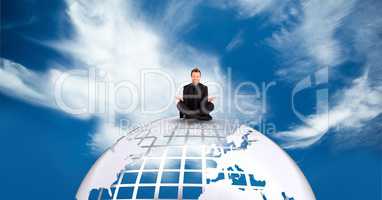 Businessman meditating on earth against sky