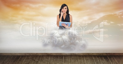 Digital composite image of woman holding tablet computer on cloud over floorboard in sky