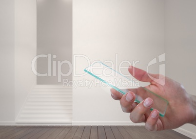 Hand holding glass screen in modern room