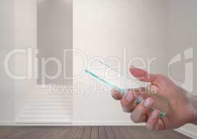 Hand holding glass screen in modern room