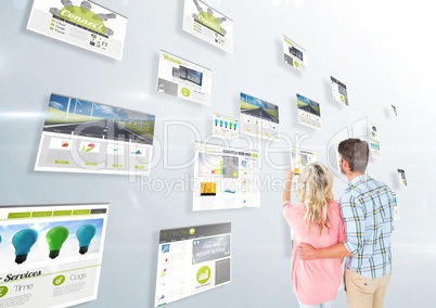 panels with websites(green) , light background and couple looking for them and fingering one
