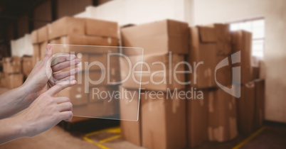 Hand using transparent device in warehouse