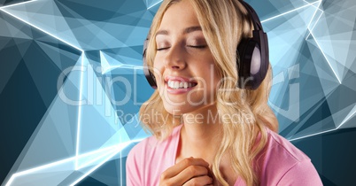 Young woman with eyes closed listening to music on headphones