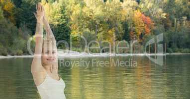 Double exposure of woman with hands clasped by lake against trees