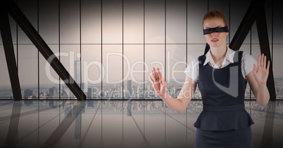 Business woman blindfolded against window and skyline