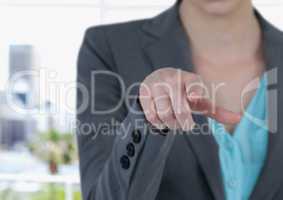 Midsection of businesswoman touching screen in office