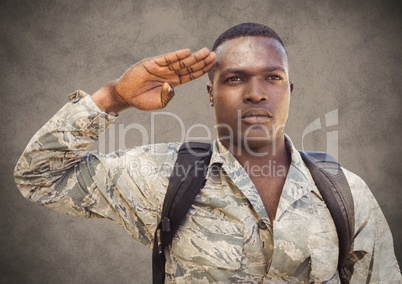 Soldier saluting against brown background with grunge overlay