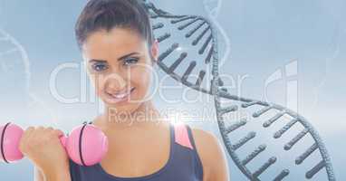 Woman lifting dumbbell against DNA structure
