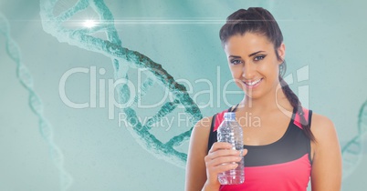 Fit young woman holding water bottle with DNA structure in background
