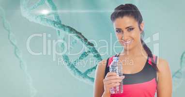 Fit young woman holding water bottle with DNA structure in background