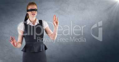 Business woman blindfolded against navy background with flare and grunge overlay