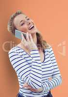 Happy woman using smart phone over peach background