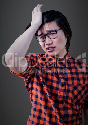 Stressed man against grey wall