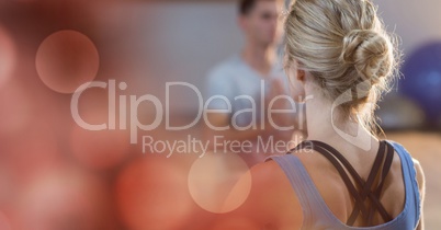 Rear view of woman doing yoga in gym